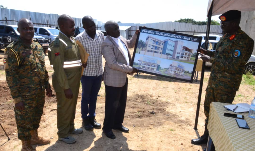 Col.Onata right handing over the construction design to the SACCO vice chairperson and the technical team