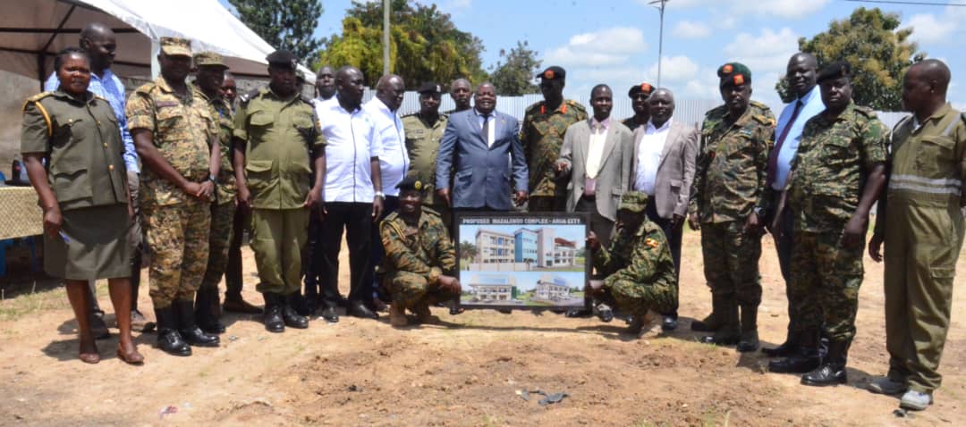 Charles Ichogor in blue suit,with the UPDF officer who are the SACCO leaders during the ground breaking.